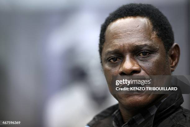 Cameroonian photographer Samuel Fosso poses in Paris on February 7, 2014. "They didn't leave a thing. They even took my bed," explained renowned...