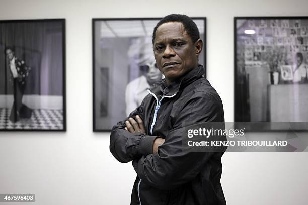 Cameroonian photographer Samuel Fosso poses in Paris on February 7, 2014. "They didn't leave a thing. They even took my bed," explained renowned...