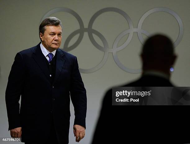 Ukrainian President Viktor Yanukovych walks through the presidential lounge to take his seat at the opening ceremony of the Sochi 2014 Winter...