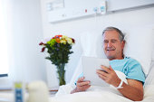 Checking his emails while in hospital