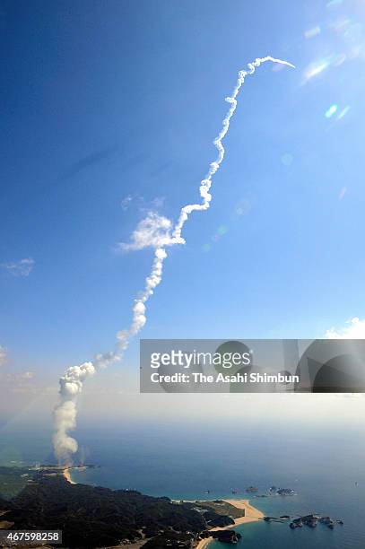 In this aerial image, the H-2A Launch Vehicle No. 28 of the Japan Aerospace Exploration Agency leaves a contrail after launch at JAXA's Tanegashima...