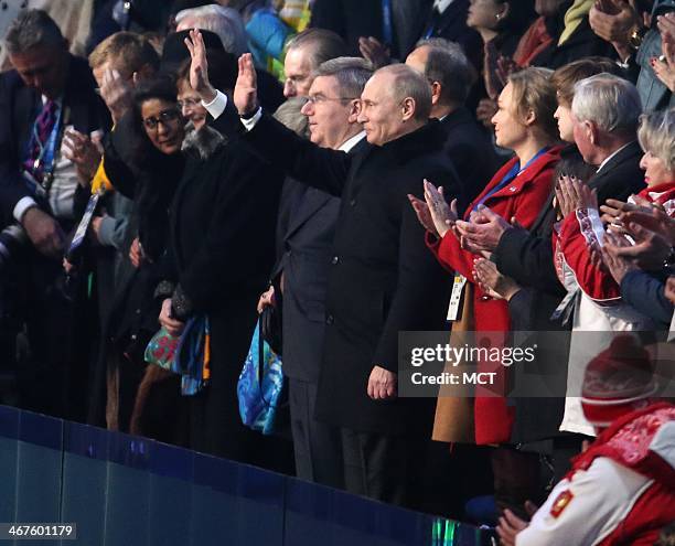Russian President Vladimir Putin waves during the Opening Ceremony for the Winter Olympics at Fisht Olympic Stadium in Sochi, Russia, Friday, Feb. 7,...