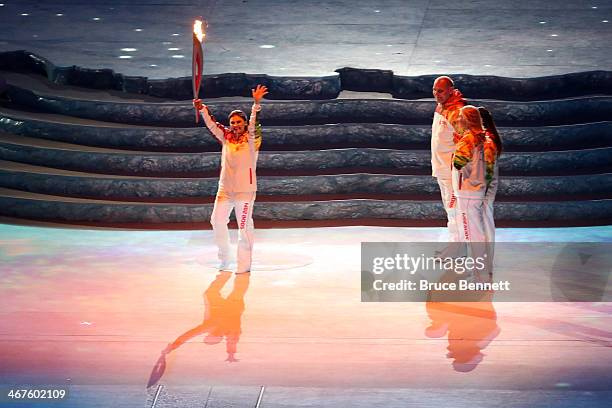 Elena Isinbaeva carries the Olympic torch during the Opening Ceremony of the Sochi 2014 Winter Olympics at Fisht Olympic Stadium on February 7, 2014...