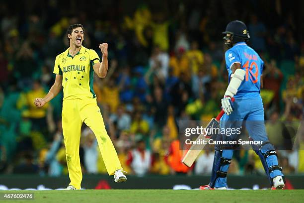 Mitchell Starc of Australia celebrates dismissing Umesh Yadav of India during the 2015 Cricket World Cup Semi Final match between Australia and India...