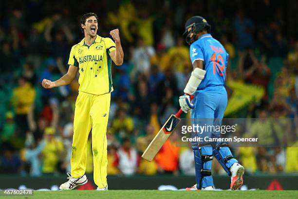 Mitchell Starc of Australia celebrates dismissing Umesh Yadav of India during the 2015 Cricket World Cup Semi Final match between Australia and India...