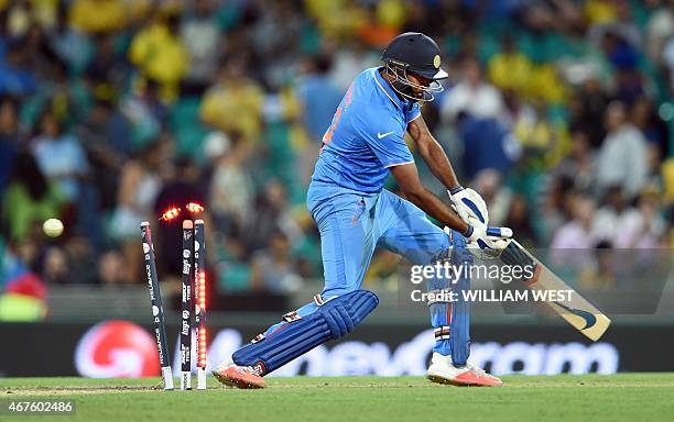 India's batsman Ravi Ashwin is bowled by Australia's James Faulkner during their 2015 Cricket World Cup semi-final match in Sydney on March 26, 2015....