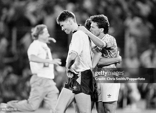 Chris Waddle of England consoled by West Germany captain Lothar Matthaus after England's defeat in the FIFA World Cup Semi-Final between England and...