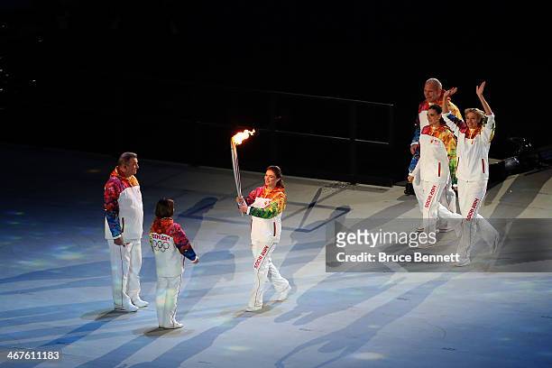 Alina Kabaeva carries the Olympic torch to Vladislav Tretyak and Irina Rodina as Alexandr Karelin , Elena Isinbaeva and Maria Sharapova look on the...