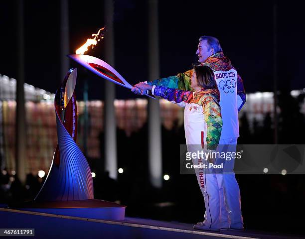 Irina Rodnina and Vladislav Tretyak light the Olympic cauldron during the opening ceremony of the 2014 Winter Olympics in Sochi, Russia, Friday, Feb....