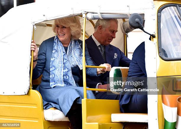 Camilla, Duchess of Cornwall and Prince Charles, Prince of Wales ride in a rickshaw at Clarence House on March 26, 2015 in London, England. In...