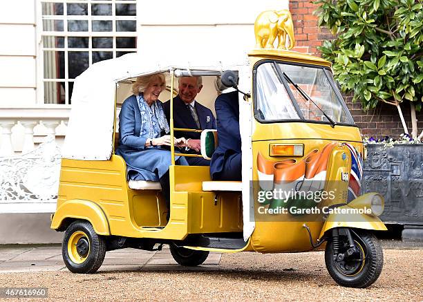 Camilla, Duchess of Cornwall and Prince Charles, Prince of Wales ride in a rickshaw at Clarence House on March 26, 2015 in London, England. In...