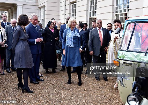 Camilla, Duchess of Cornwall and Prince Charles, Prince of Wales stand next to a rickshaw at Clarence House on March 26, 2015 in London, England. In...