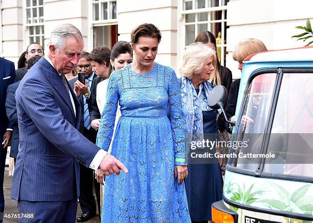 Camilla, Duchess of Cornwall and Prince Charles, Prince of Wales are shown a rickshaw by Yasmin Le Bon at Clarence House on March 26, 2015 in London,...