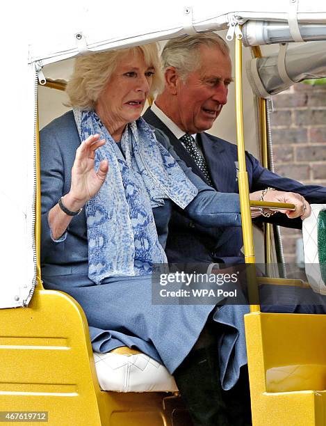 Camilla, Duchess of Cornwall and Prince Charles, Prince of Wales ride in a rickshaw at Clarence House on March 26, 2015 in London, England. In...