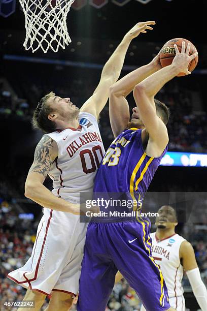 Ryan Spangler of the Oklahoma Sooners tries to block the shot of Greig Stire of the Albany Great Danes during the second round of the 2015 NCAA Men's...