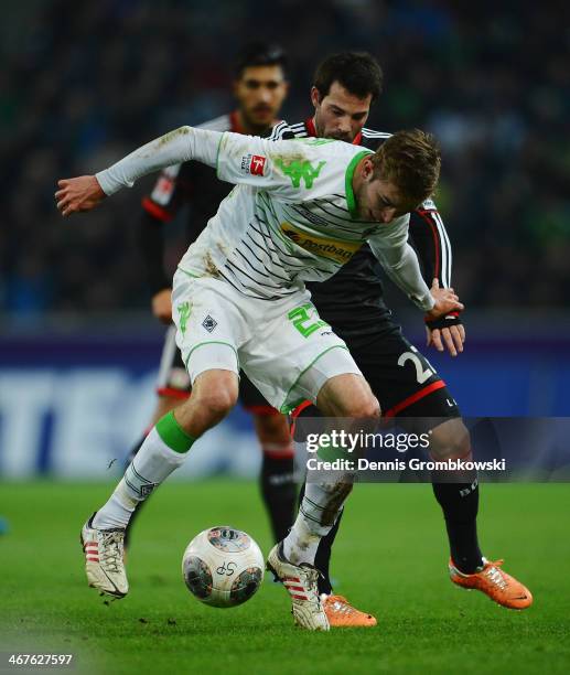 Tony Jantschke of Borussia Moenchengladbach is challenged by Gonzalo Castro of Bayer Leverkusen during the Bundesliga match between Borussia...