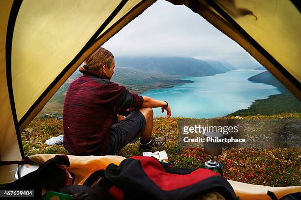 hiking young man and scenic view of lake gjende jotunheimen - camping bildbanksfoton och bilder