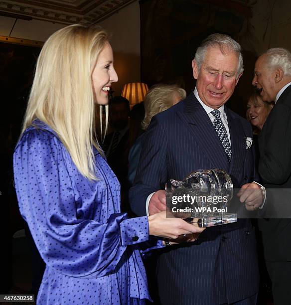 Ruth Powys, Chief Executive, Elephant Family, presents Prince Charles, Prince of Wales with a rhinoceros sculpture, The Perfect World Foundation's...