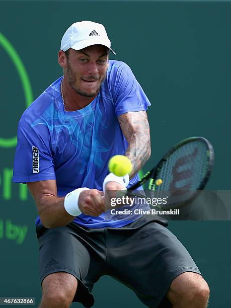 Andreas Haider-Maurer of Austria plays a backhand against Borna Coric of Croatia in their first round match during the Miami Open at Crandon Park...