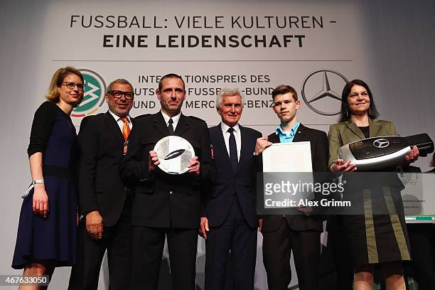 Jimmy Hartwig, DFB Vice President Eugen Gehlenborg and Laura Tilly, head of Global Diversity Office Daimler AG, pose with representatives of...