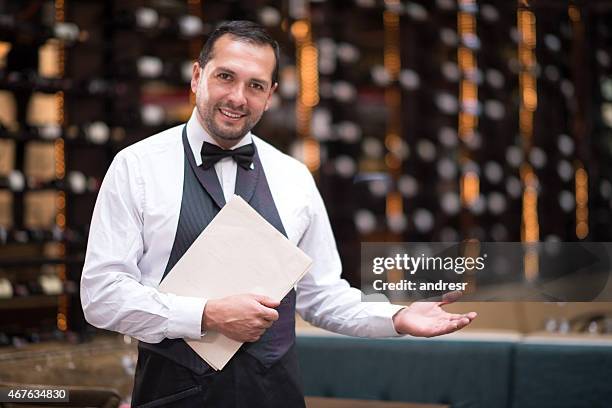 waiter welcoming people to a restaurant - party host stock pictures, royalty-free photos & images