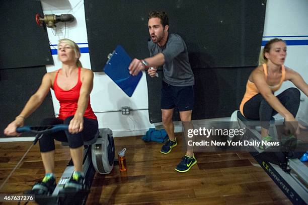 Julie Solomon and Coleen McCoy with instructor Michael Aiken at the Brooklyn Crew studio which holds a rowing fitness class at 20 Broadway in...