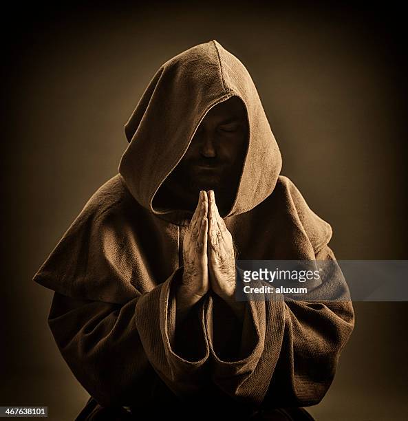 monk praying - hood clothing stock pictures, royalty-free photos & images