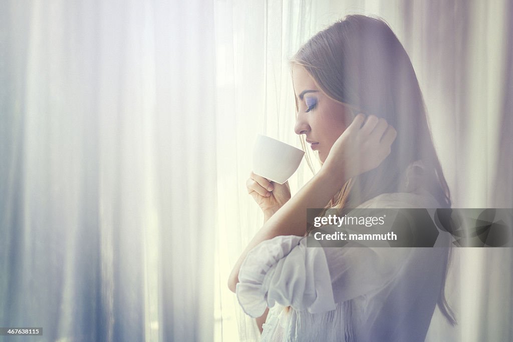 Jeune femme buvant un café