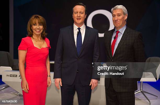 In this handout provided by Sky News, Kay Burley of Sky News, British Prime Minister David Cameron and Jeremy Paxman of Channel 4 pose ahead of the...