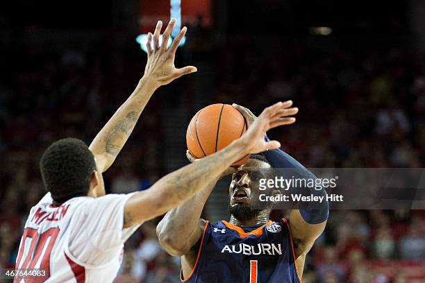 Harrell of the Auburn Tigers shoots the ball while being defended by Rashad Madden of the Arkansas Razorbacks at Bud Walton Arena on January 25, 2014...