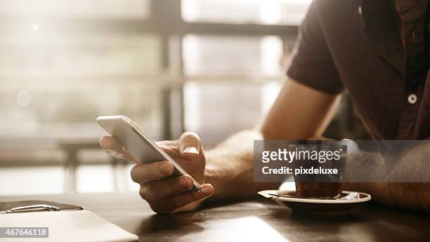 where the coffee and connection are strong - mobile device on table stock pictures, royalty-free photos & images