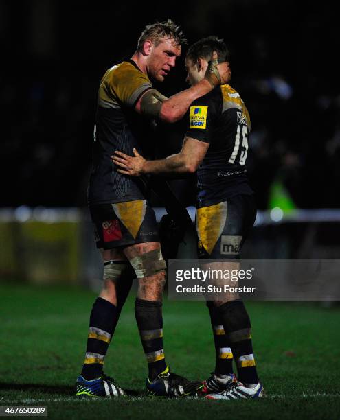 Warriors forward James Percival consoles full back Chris Pennell after their narrow defeat in the Aviva Premiership match between Worcester Warriors...