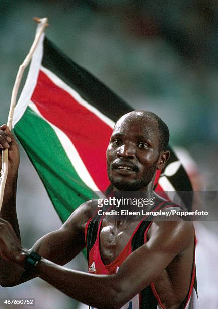 William Tanui of Kenya with his country's flag after winning the men's 800 metres event at the Olympic Games in Barcelona, circa August 1992.