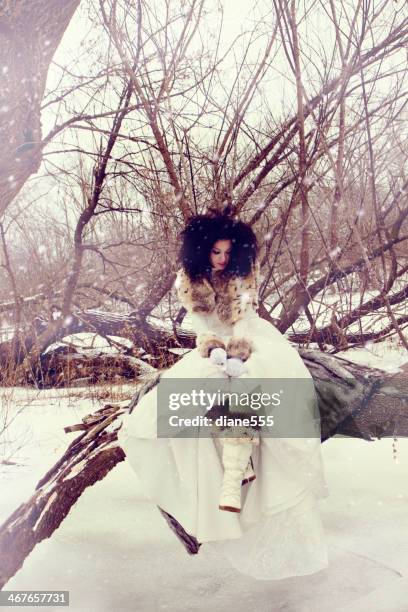 beautiful woman wearing a wedding gown in the snow - winter bride stock pictures, royalty-free photos & images