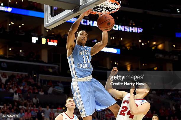 Brice Johnson of the North Carolina Tar Heels dunks the ball against Bronson Koenig of the Wisconsin Badgers in the firs thalf during the West...