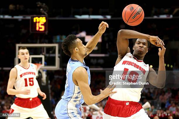 Nigel Hayes of the Wisconsin Badgers looses the ball alongside J.P. Tokoto of the North Carolina Tar Heels in the first half during the West Regional...