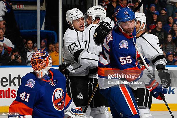 Jaroslav Halak and Johnny Boychuk of the New York Islanders look on as Nick Shore of the Los Angeles Kings is congratulated by teammate Dustin Brown...