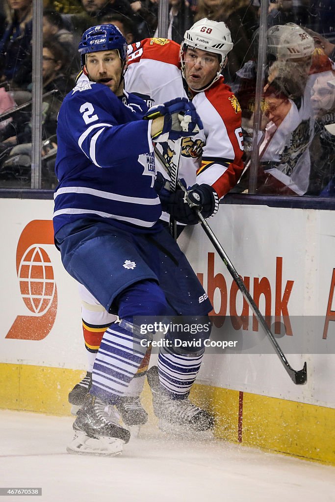 Eric Brewer (2) of the Toronto Maple Leafs put Jaromir Jagr (68) of the Florida Panthers into the end boards