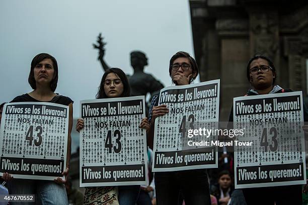 Demonstrators hold banners of the 43 missing students of Ayotzinapa college during a rally to ask Mexican authorities to continue the search for the...