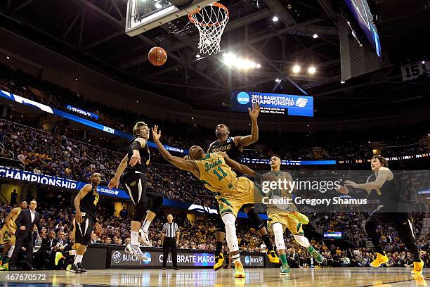 Demetrius Jackson of the Notre Dame Fighting Irish drives to the basket against Ron Baker and Shaquille Morris of the Wichita State Shockers in the...