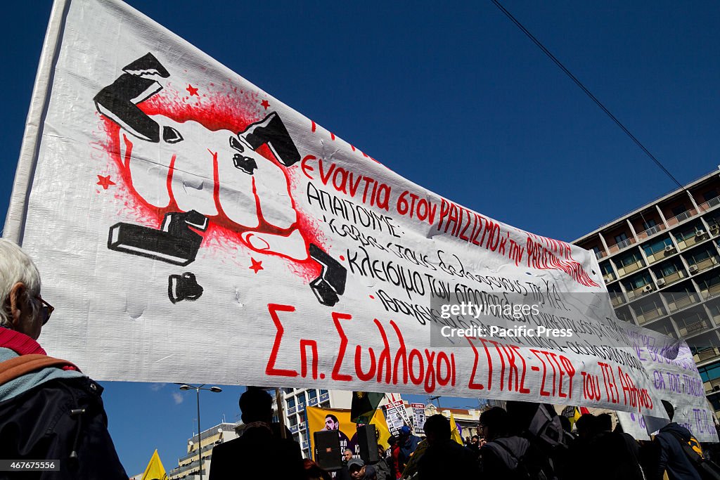 People hold a banner with anti-fascist slogans. Unions,...