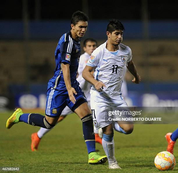 Santiago Maderos of Uruguay and Julian Chicco of Argentina vie for the ball during their U-17 South American final round football match at Dr Nicolas...