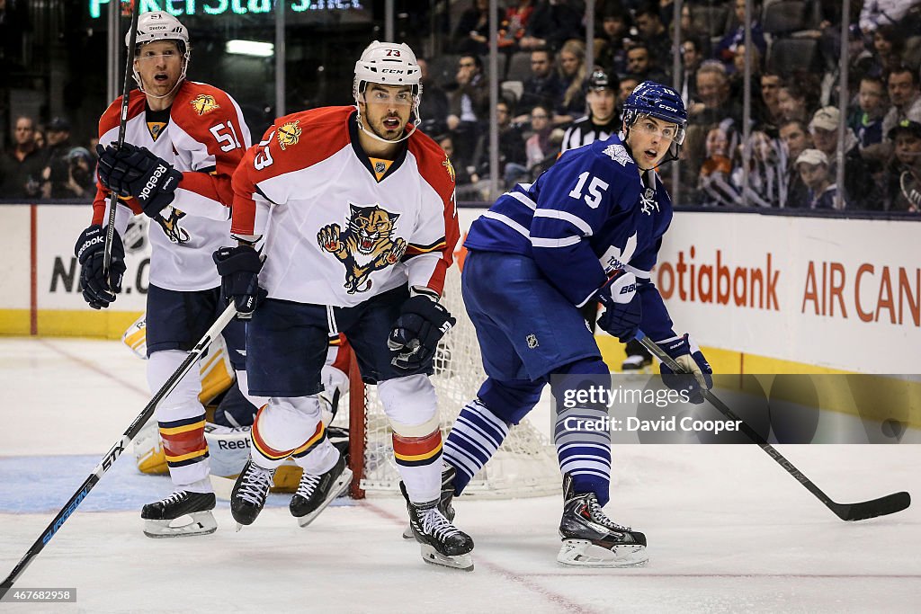 Joakim Lindstrom (15) of the Toronto Maple Leafs and Joakim Lindstrom (15)of the Florida Panthers look to the corner for the puck