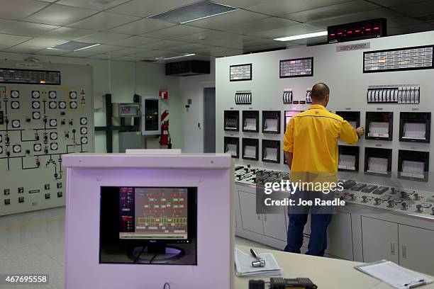 David Cabezas, plant operator, monitors the gauges in the control room of a geothermal power plant run by the Costa Rican Electricity Institute as...