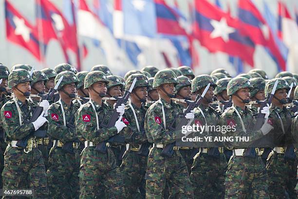 Members of Myanmar's military march in formation during a ceremony to mark the 70th anniversary of Armed Forces Day in Myanmar's capital Naypyidaw on...