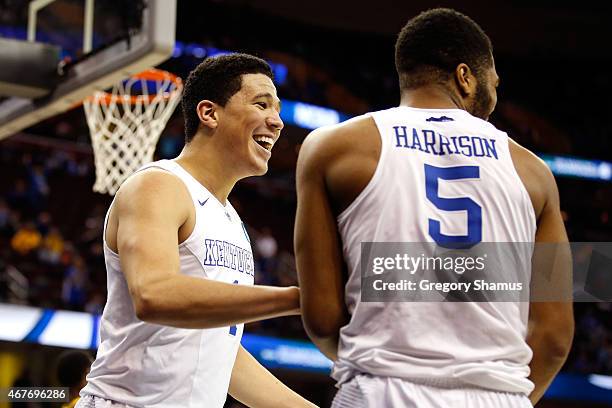 Devin Booker of the Kentucky Wildcats reacts with Andrew Harrison after a basket in the second half against the West Virginia Mountaineers during the...