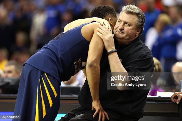 Gary Browne of the West Virginia Mountaineers reacts with his head coach Bob Huggins as he exits the game against the Kentucky Wildcats during the...