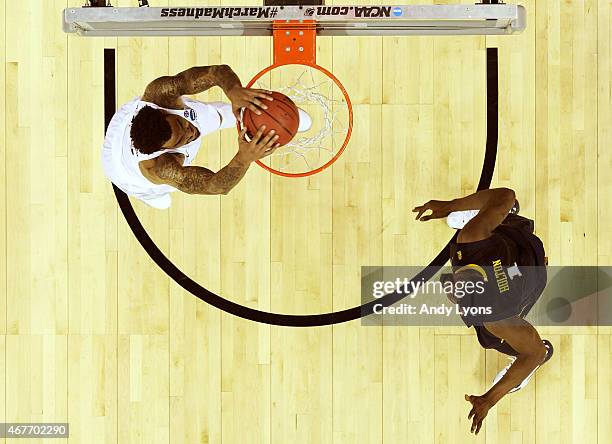 Willie Cauley-Stein of the Kentucky Wildcats goes up for a dunk in the first half against Jonathan Holton of the West Virginia Mountaineers during...