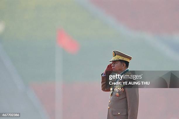 Myanmar Military Commander in Chief Senior General, Min Aung Hlaing salutes to the national flag during a ceremony to mark the 70th anniversary of...
