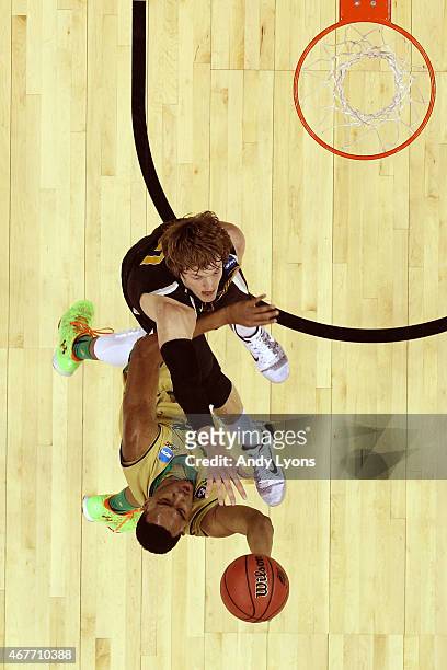Bonzie Colson of the Notre Dame Fighting Irish drives to the basket against Ron Baker of the Wichita State Shockers during the Midwest Regional...